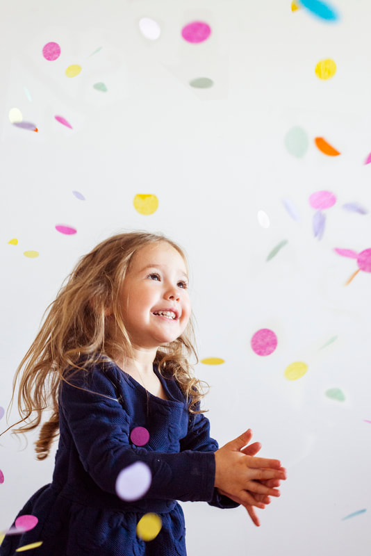 girl in a navy blue dress covered in confetti