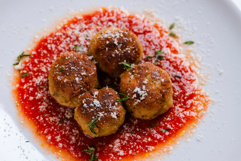 Vegetarian ricotta balls. served with tomato sauce.