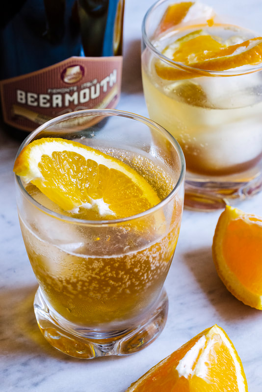 Cocktail with ice and orange slices.