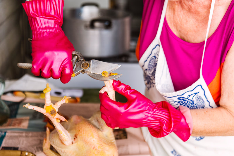 Woman clipping chicken claws.