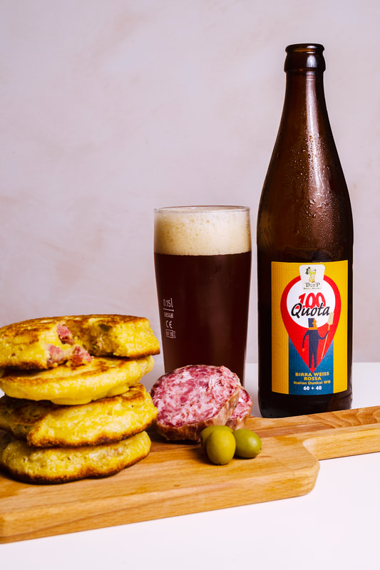 Food and beer pairing. Cornmeal pancakes with Dunkel beer poured in a beer glass.